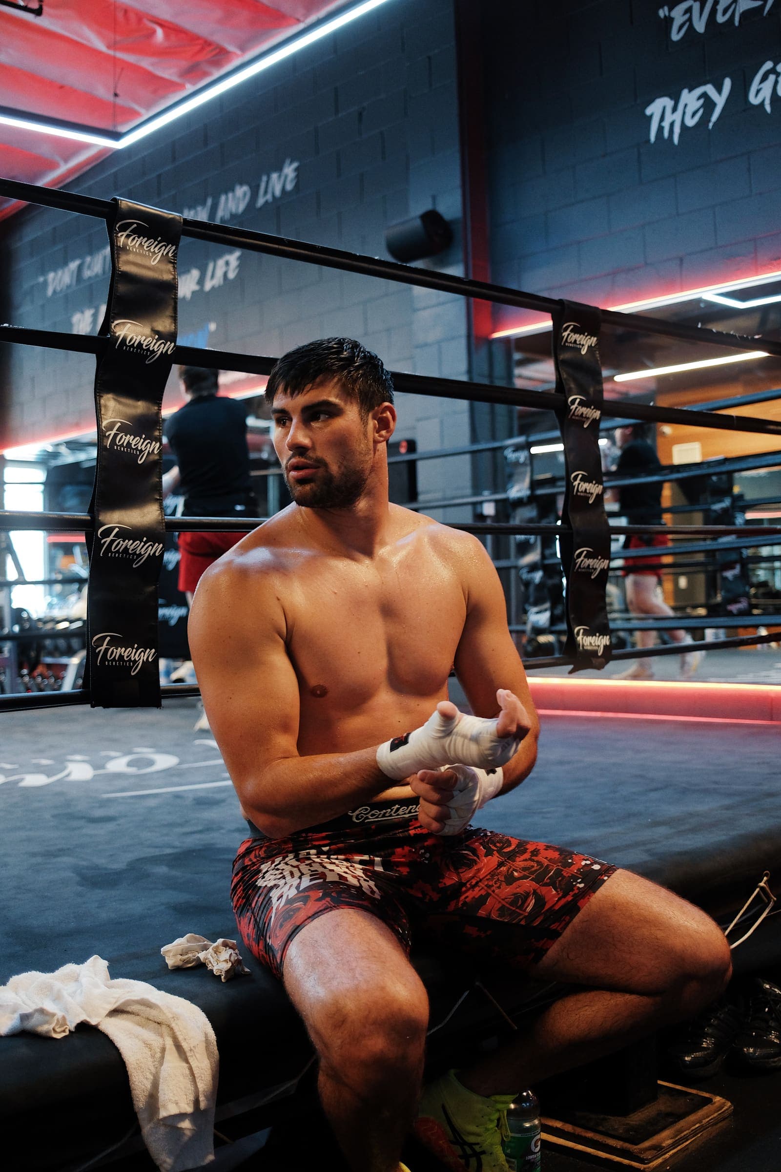 Andrii Novytskyi tightening his hand wraps on the ring apron